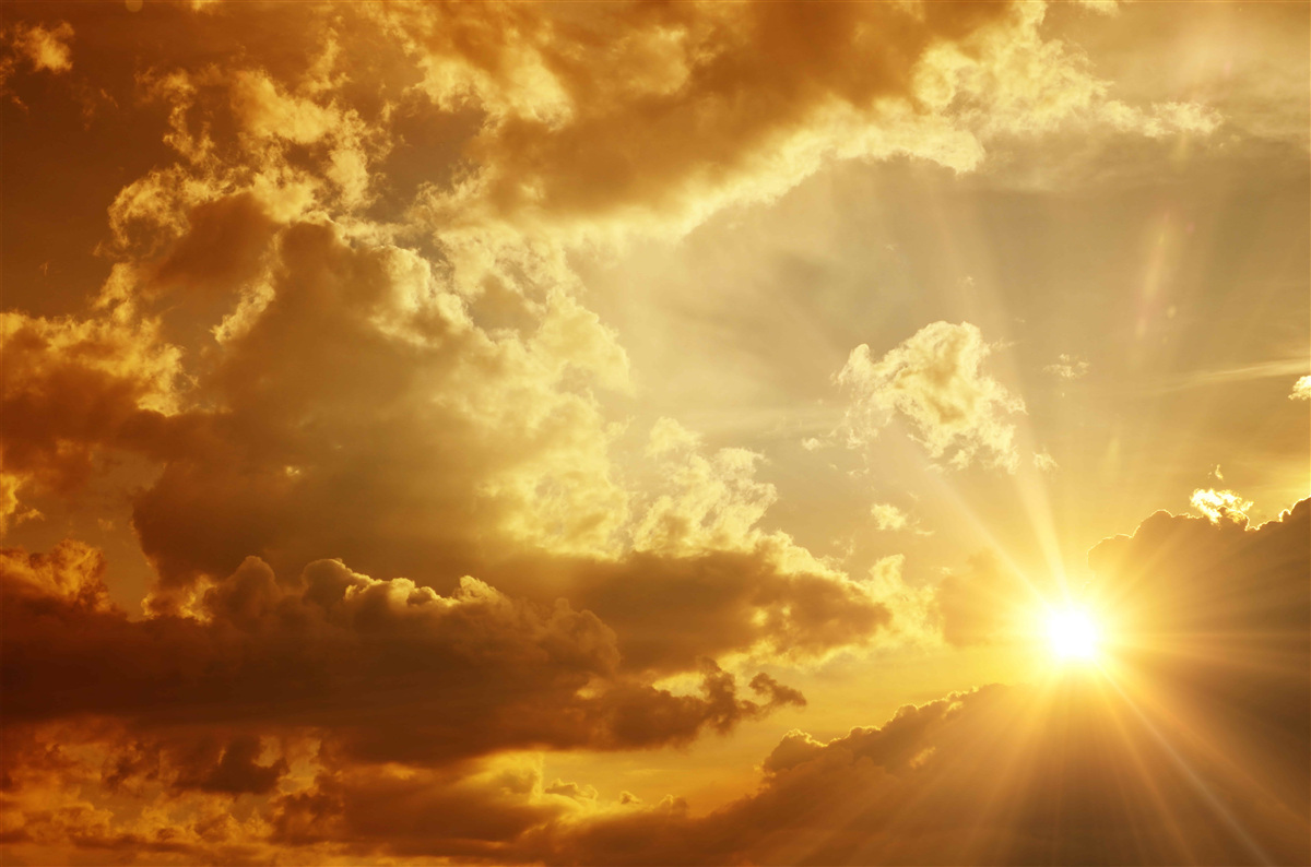 Fototapeta promienie słoneczne przebijające się przez chmury o zachodzie słońca emitują ciepło