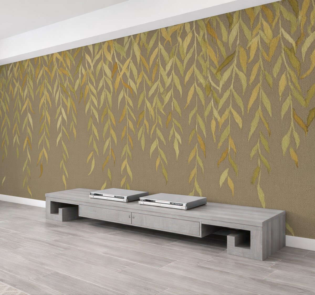 Fototapeta Gałęzie wierzby z liśćmi w odcieniach żółci i zieleni opadające na brązowym płóciennym tle.