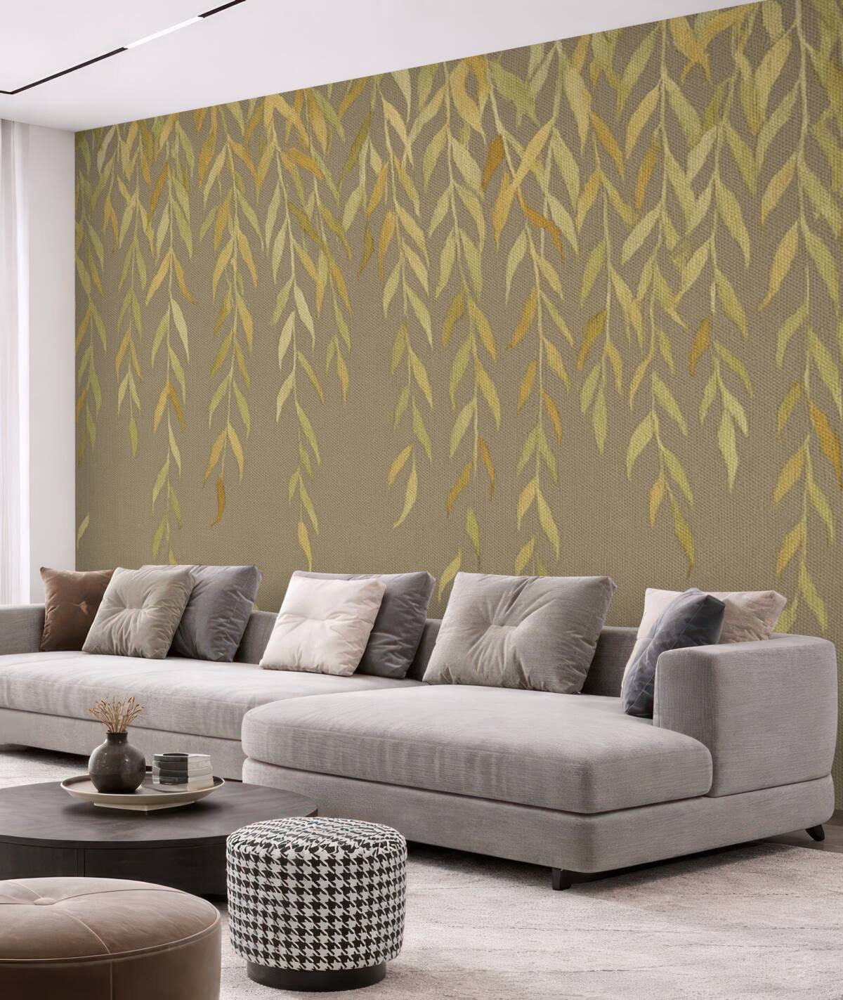 Fototapeta Gałęzie wierzby z liśćmi w odcieniach żółci i zieleni opadające na brązowym płóciennym tle.