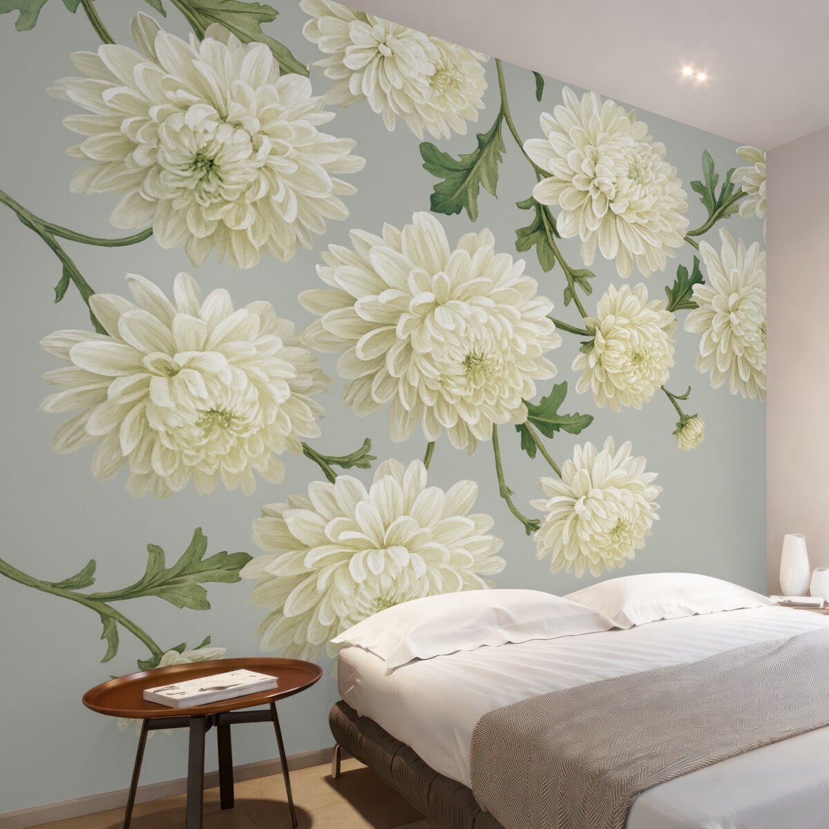 Fototapeta Białe kwiaty chryzantem z zielonymi liśćmi na jasnoszarym tle.